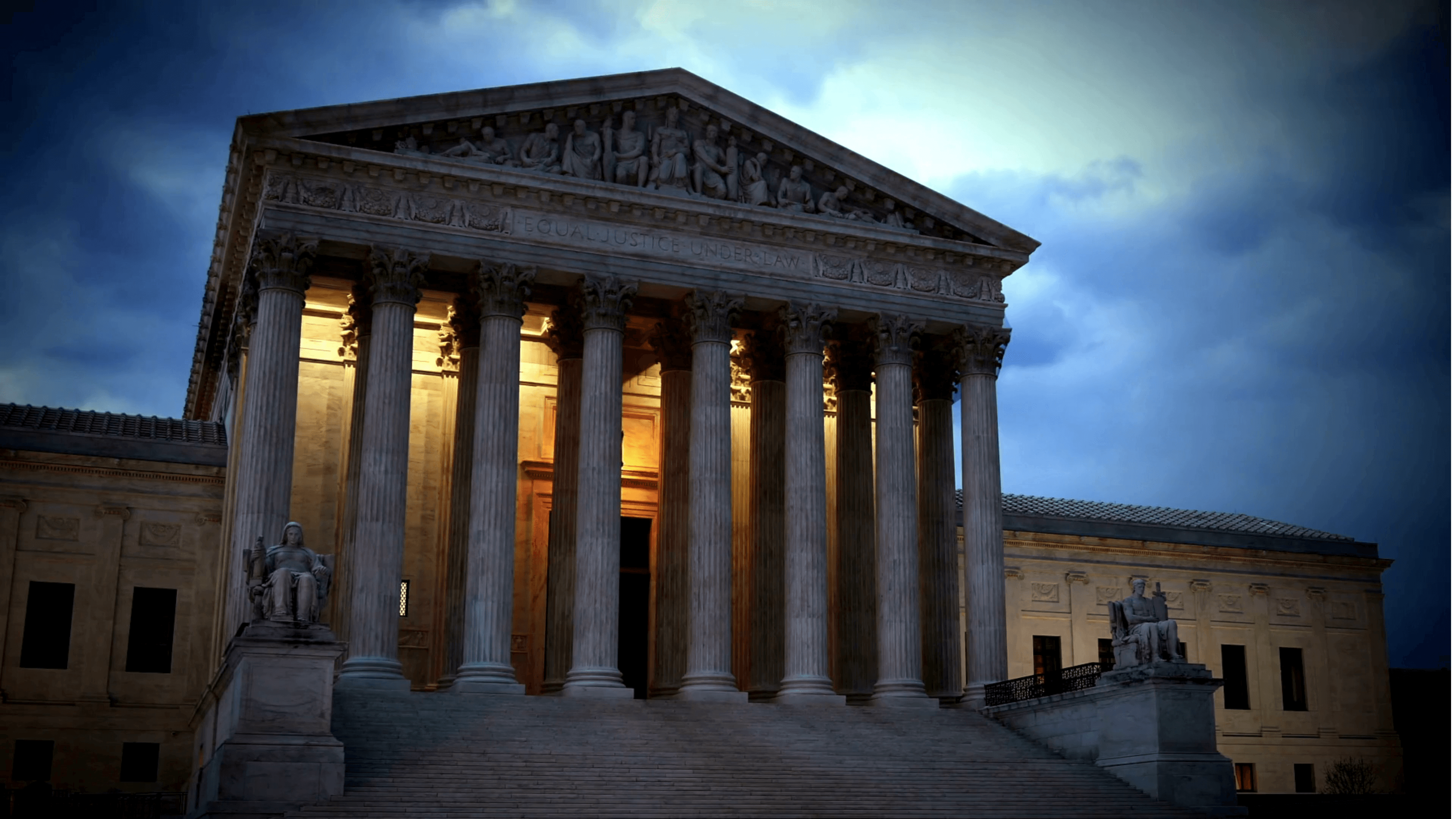 Classical courthouse columns against a stormy sky